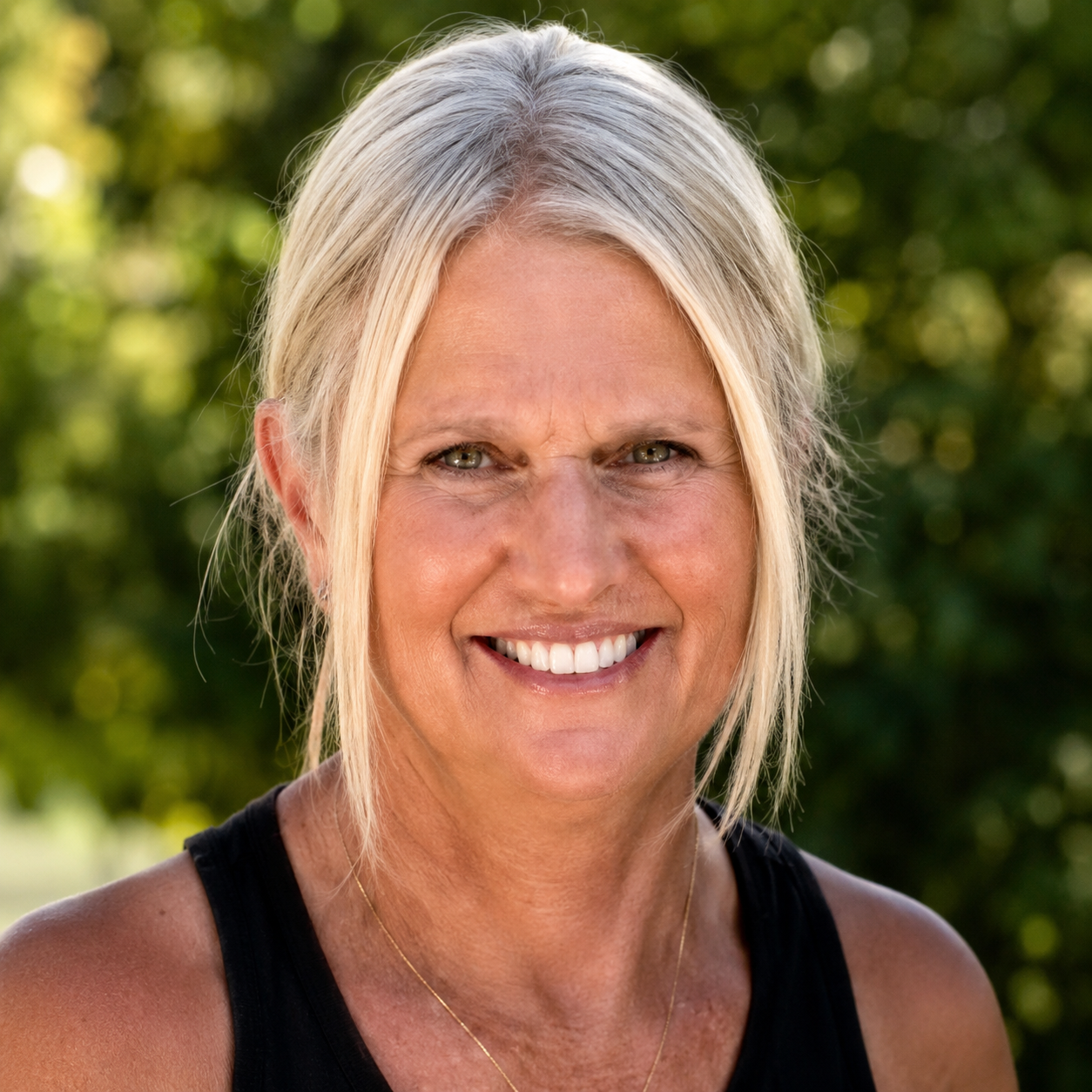 Connie Grevengoed, founder of HolyFit45, smiling warmly outdoors
